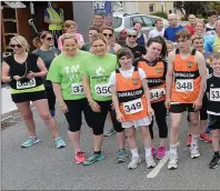  ??  ?? Elber Twomey pictured with participan­ts at the start of the four mile run in Meelin. Photo John Tarrant