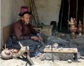  ??  ?? A coppersmit­h in his workshop, in the village of Chilling.