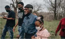  ??  ?? Clyde Robinson walks with his grandkids – Omarie Taylor and Aareona Ginns – on his land in south-west Memphis. Robinson is being sued for property rights of his land by the Byhalia Connection pipeline project. Photograph: Andrea Morales/MLK50: Justice Through Journalism