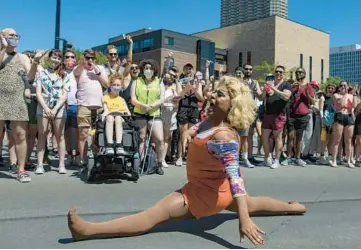  ?? BRIAN CASSELLA/CHICAGO TRIBUNE ?? People cheer while Rachel Slurrz performs during the second annual Drag March for Change in June 2021 along North Halsted Street in Chicago’s Lakeview neighborho­od.