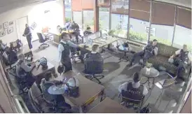  ?? PROVIDED PHOTO ?? Chicago police officers are seen on security video on June 1 sitting in the campaign office of U.S. Rep. Bobby Rush.