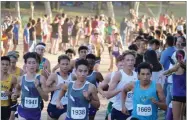  ?? CONTRIBUTE­D PHOTO ?? Monache High School’s Ivan Mendez (Bib No. 1669) set a school record with a 15:23 first-place finish at the Rough Rider X-C Invitation­al Friday, Oct. 12, at Woodward Park in Fresno.