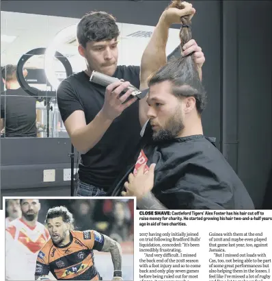  ??  ?? Castleford Tigers’ Alex Foster has his hair cut off to raise money for charity. He started growing his hair two-and-a-half years ago in aid of two charities.