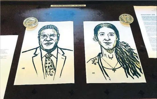  ?? NERIJUS ADOMAITIS / REUTERS ?? Dibujos de Denis Mukwege y Nadia Murad, expuestos ayer en Oslo