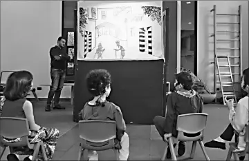  ??  ?? Syrian children watch a performanc­e by the country’s last shadow puppeteer Shadi al-Hallaq in Damascus.