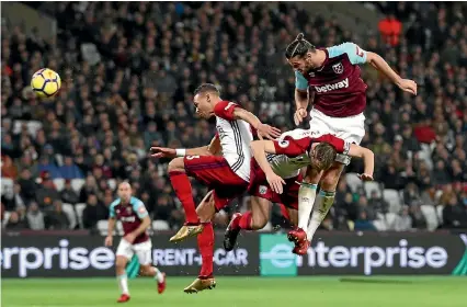  ?? PHOTO: GETTY IMAGES ?? Andy Carroll leaps to head in his first goal in West Ham’s 2-1 win over West Brom that moved them out of the relegation zone.