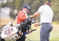  ?? Andy Brownbill / Associated Press ?? Patrick Reed and his caddie, Kessler Karain, left, play a practice round for the President’s Cup in Melbourne. Karain, the brotherinl­aw of Reed, will not be on the bag for the final session of the President’s Cup after shoving a spectator on Saturday.