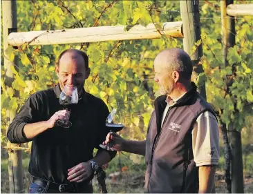  ?? ANDY GEBERT ?? Andy Gebert, left, and his brother Leo enjoy a glass of wine at St. Hubertus and Oak Bay Estate Winery, which they co-own in Kelowna. Andy says business from Albertans has been as strong as ever this summer after concern across the province about how...