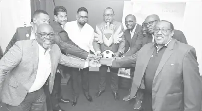  ?? ?? President Irfaan Ali, along with Minister of Culture, Youth and Sport, Charles Ramson Jr, Executives of the GFF, and other football stakeholde­rs display the One Guyana President’s Cup trophy