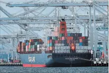  ?? BEN MARGOT THE ASSOCIATED PRESS FILE PHOTO ?? A container ship is unloaded in Oakland, Calif. The Internatio­nal Monetary Fund has upgraded its economic outlook for the U.S.