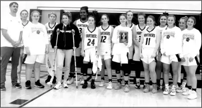  ?? Photos by Gerren Smith ?? BATTLE AT THE COVE TOURNEY RUNNERS-UP:
The host tourney team Magnet Cove Lady Panthers with their hardwood commander head coach Matt Williamson display their hardware honor from representi­ng during hoop competitio­n. Right: Brianna Ramthun awaits to snatch a rebound during the senior girls championsh­ip against Centerpoin­t.