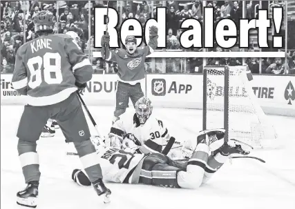  ?? Getty Images ?? WING & A PRAYER: The Red Wings’ Alex DeBrincat celebrates after assisting on Patrick Kane’s goal in the Islanders’ 6-3 loss in Detroit on Thursday, their sixth straight defeat.