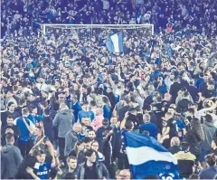  ?? AFP ?? Everton fans invade the pitch to celebrate after the EPL match between Everton and Crystal Palace at Goodison Park on Thursday.