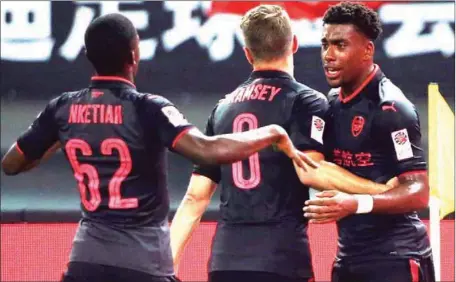  ??  ?? Arsenal’s Alex Iwobi (right) and teammates celebratin­g the equaliser against Bayern Munich in Shanghai yesterday. Arsenal defeated Bayern 3-2 on penalties