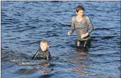  ?? 01_B02dook11 ?? This youngster, who brought along a small paddle board, was reluctant to leave the water.