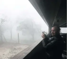  ?? JOE RAEDLE/GETTY IMAGES ?? Derik Kline takes shelter in a parking garage as Hurricane Michael passes through the Panama City area of Florida on Wednesday after making landfall as a category 4 storm.