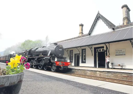  ?? Picture: Kris Miller. ?? A steam train passes through Dunkeld railway station. However, the reality is less romantic, with south-bound passengers having to climb boxes to get on trains because the platform is too low.