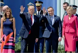  ?? — AP ?? US President Donald Trump waves along with Poland’s President Andrzej Duda as US First Lady Melania Trump and her Polish counterpar­t Agata Kornhauser- Duda stand by in Krasinski Square, Warsaw, on Thursday
