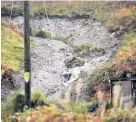  ??  ?? Floodwater pours down the mountain