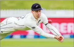  ?? AFP ?? New Zealand’s Will Young dives in an effort to catch the ball during the third day of the first Test cricket match between New Zealand and West Indies at Seddon Park in Hamilton on Saturday.