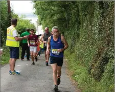  ??  ?? Sean Clancy and a group of runners on the Glen Road.