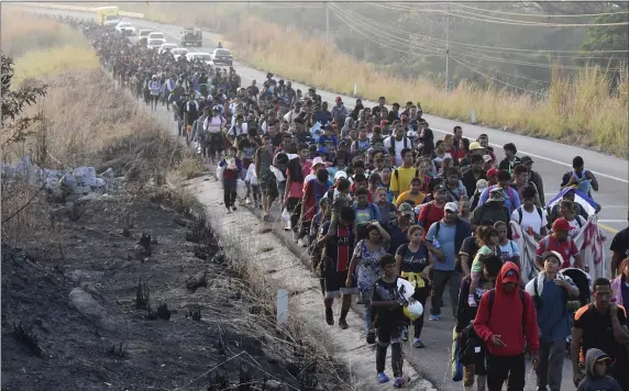  ?? EDGAR H. CLEMENTE — THE ASSOCIATED PRESS ?? Migrants walk along the highway through Arriaga, Chiapas state in southern Mexico, earlier this month during their journey north toward the U.S. border.