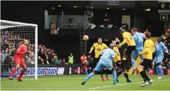  ??  ?? LONDON: Stoke City’s Charlie Adam heads the ball which becomes their first goal of the game after hitting Watford goalkeeper Heurelho Gomes during the English Premier League soccer match between Watford and Stock City at Vicarage Road, London, yesterday. —AP