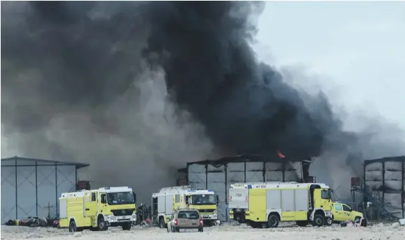  ?? The National ?? Abu Dhabi Civil Defence crews attend the fire at the workers’ accommodat­ion in the Al Reef area