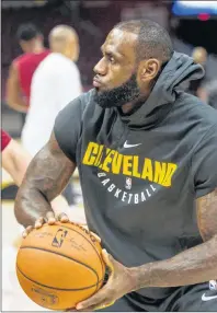  ?? AP PHOTO ?? Cleveland Cavaliers’ LeBron James warms up before playing an NBA preseason game against the Chicago Bulls in Cleveland on Tuesday.