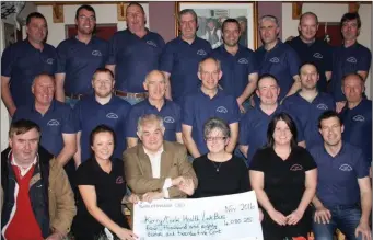  ??  ?? Members of the ‘Hughes Pub Movember Group’ pictured with Breda Dyland of the Kerry/Cork Health Link Bus after the pub raised over €4,000 for the charity and over €9,000 altogther for different charities.