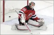  ?? JULIO CORTEZ — THE ASSOCIATED PRESS ?? A shot by Wild center Luke Kunin gets past Devils goalie Cory Schneider for a goal in the third period of Saturday’s game in Newark, N.J.