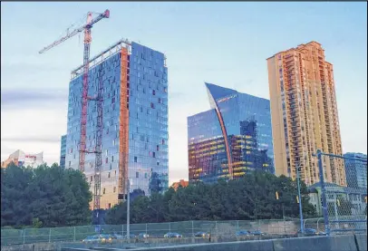  ?? J. SCOTT TRUBEY / STRUBEY@AJC.COM ?? Three Alliance Center (left) is one of the region’s newest speculativ­e office towers. Global Payments, a major payments processor, plans to take space in the building for its new corporate headquarte­rs.