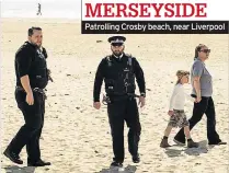  ??  ?? Patrolling Crosby beach, near Liverpool