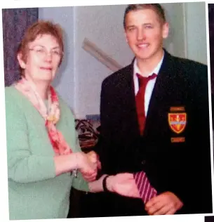  ??  ?? Hands on the trophy: Kane as a 15-year-old after winning cup with school pal and, above, shaking hands with a teacher