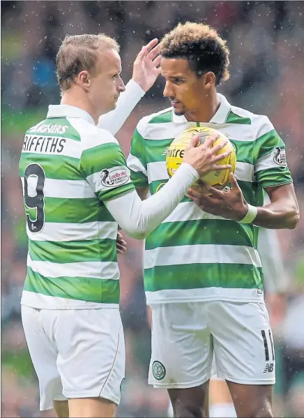  ??  ?? OVER TO YOU: Leigh Griffiths, left, lets Scott Sinclair take Celtic’s penalty in order to stay on course for a club record