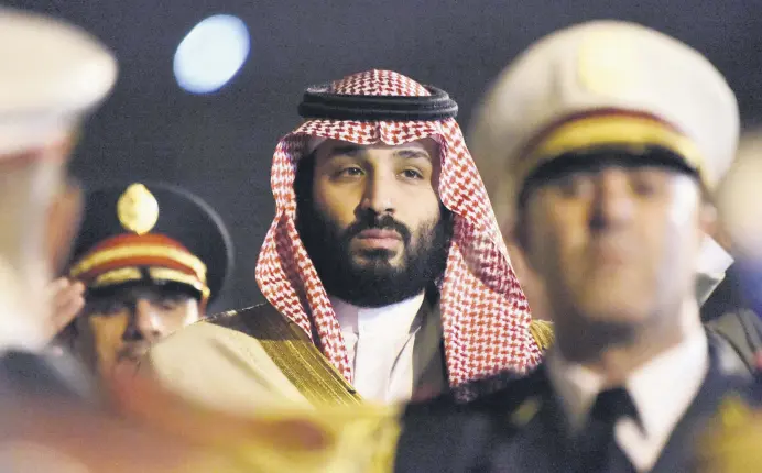  ??  ?? Saudi Crown Prince Mohammed bin Salman is seen behind a military band upon his arrival at Algiers Internatio­nal Airport, southeast of the capital Algiers on Dec. 2.