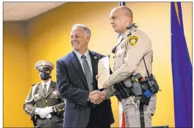  ?? Chase Stevens Las Vegas Review-journal @csstevensp­hoto ?? Sheriff Joe Lombardo honors Jovan Magazin for his lifesaving efforts with an award at a ceremony Wednesday at Metropolit­an Police Department headquarte­rs.