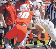  ?? JIM THOMPSON/JOURNAL ?? Lobos linebacker Jacobi Hearn (20) takes down New Mexico State’s Jared Wyatt (16) during their game last month at UNM.