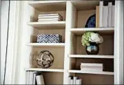  ??  ?? All-white books placed on a shelf mixed with decorative elements add an element of glam.