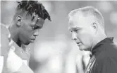  ?? LYNNE SLADKY/AP ?? Miami quarterbac­k N’Kosi Perry, left, has bounced in and out of head coach Mark Richt’s starting lineup.