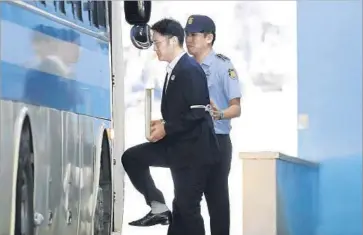  ?? Chung Sung-Jun Pool Photo ?? LEE JAE-YONG, Samsung’s de facto chief and grandson of the company’s founder, is escorted away after he was sentenced in a Seoul courtroom for his involvemen­t in a bribery and embezzleme­nt scheme.