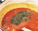  ?? ?? Stir in the crushed tomatoes, herbs de Provence, oregano, thyme and pepper. Simmer, covered, for 8 minutes. Taste and adjust the seasoning, if needed.