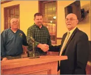  ?? / Sean Williams ?? Rockmart Recreation’s Jeff Hulsey and Mayor Steve Miller joined Chris Alvey for a check presentati­on to help cover the cost of new scoreboard­s.