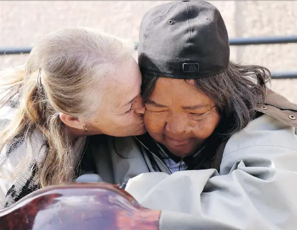  ?? ARTHUR WHITE-CRUMMEY ?? Tricia Mills gives double-amputee Marlene Bird a hug and a kiss in Prince Albert on Tuesday after giving her a donated scooter that came from ‘generous people’ in the province. “Now I can walk ... pretend I have legs,” said Bird, whose old scooter was...