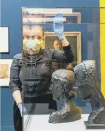  ?? ?? ART LEGACY:
Left, curatorial assistant Maraiga Bailey, looking over the works; above right,
Louisa Briggs with a portrait of Edith Sitwell, by Roger Fry and below left, at work on the displays; below right,
Sean Crawford, assistant loans registrar for the National Portrait Galley.