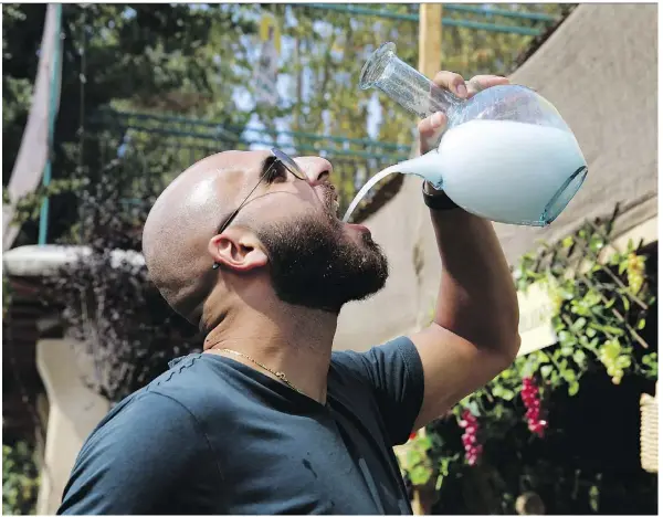  ?? PHOTOS: HUSSEIN MALLA/THE ASSOCIATED PRESS ?? Lebanese arak turns milky white when mixed and is often served in a pitcher for easy pouring.