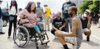  ?? PAT NABONG/SUN-TIMES ?? Sen. Tammy Duckworth speaks with a fellow participan­t at a downtown Juneteenth march.