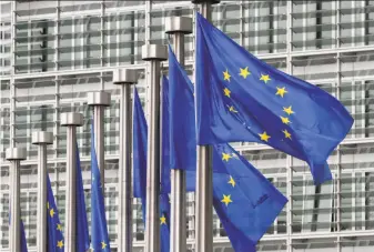  ?? Yves Logghe / Associated Press 2011 ?? EU flags fly outside the European Commission headquarte­rs in Brussels. Domestic groups, rather than foreign powers, are pushing false informatio­n and extremist messages, experts say.