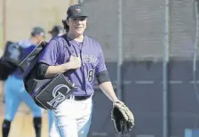  ??  ?? Ryan Rolison walks to a drill during a spring training practice earlier this month in Scottsdale, Ariz. The 22-year-old left-hander is the youngest pitcher in Colorado’s big-league camp and will likely start in Double-A Hartford.Darron