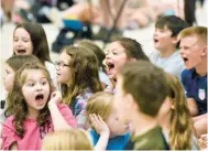  ?? ?? Kids are shocked during the assembly when they hear that one of their teachers is getting a special award.